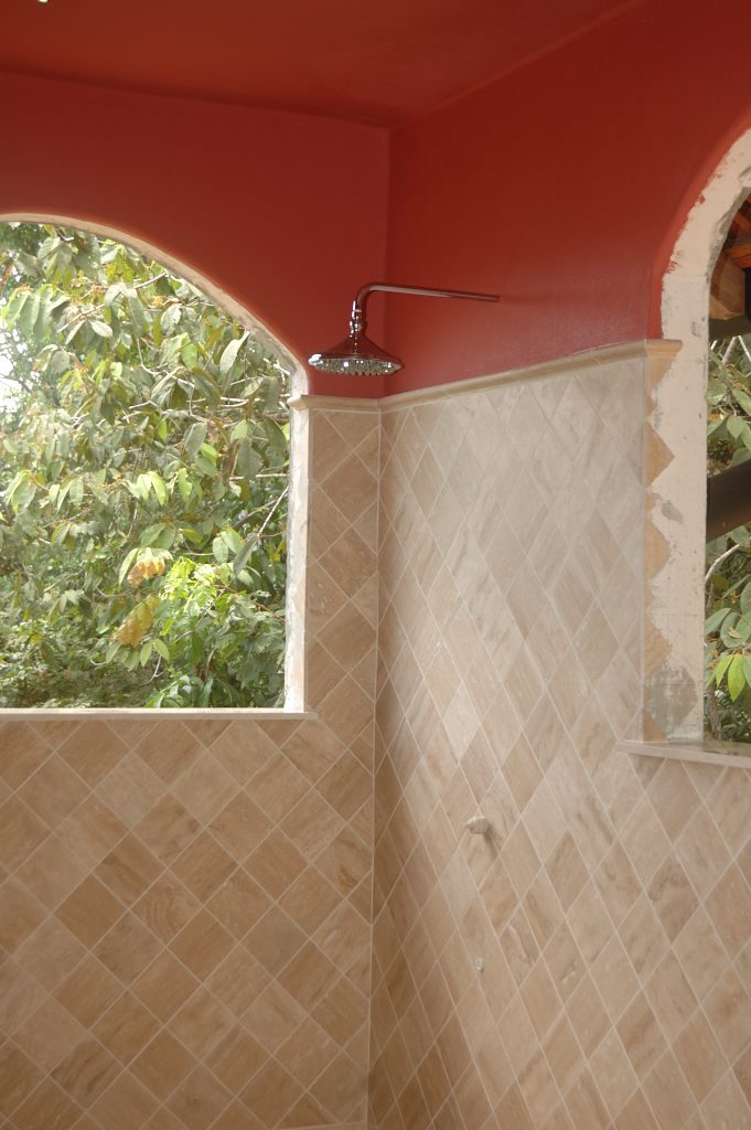 Travertino Tiles of the Bathroom of a Fine House/Lodge in the Hills of the Osa Peninsula, by Rarewood General Contractor in Puerto Jimenez