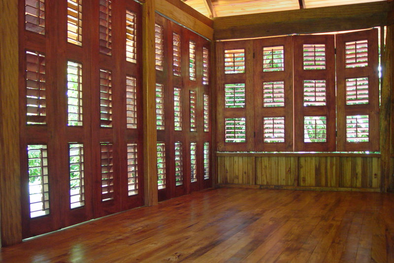 Interior view of a Harwood Cabin with folding -sliding louvered doors and windows Built by Rarewood General Contractor in Puerto Jimenez Osa Peninsula